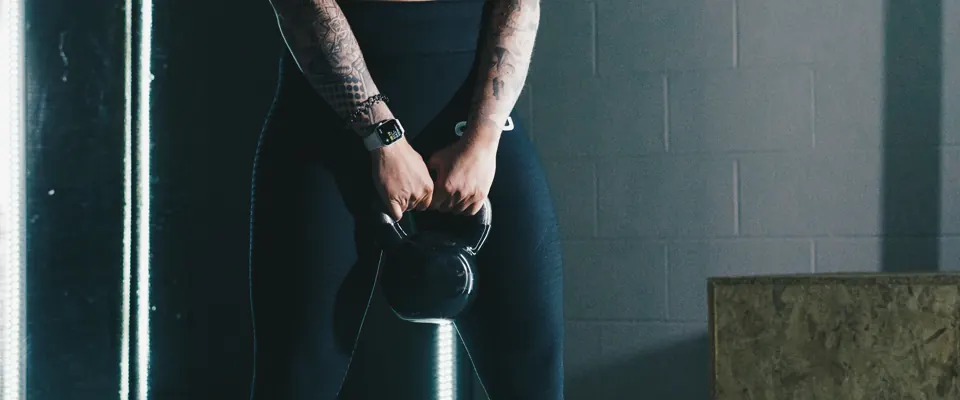Athlete holding a kettlebell in a quiet gym